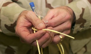 Guantanamo bay doctor holds feeding tube used to feed detainees on hunger strike